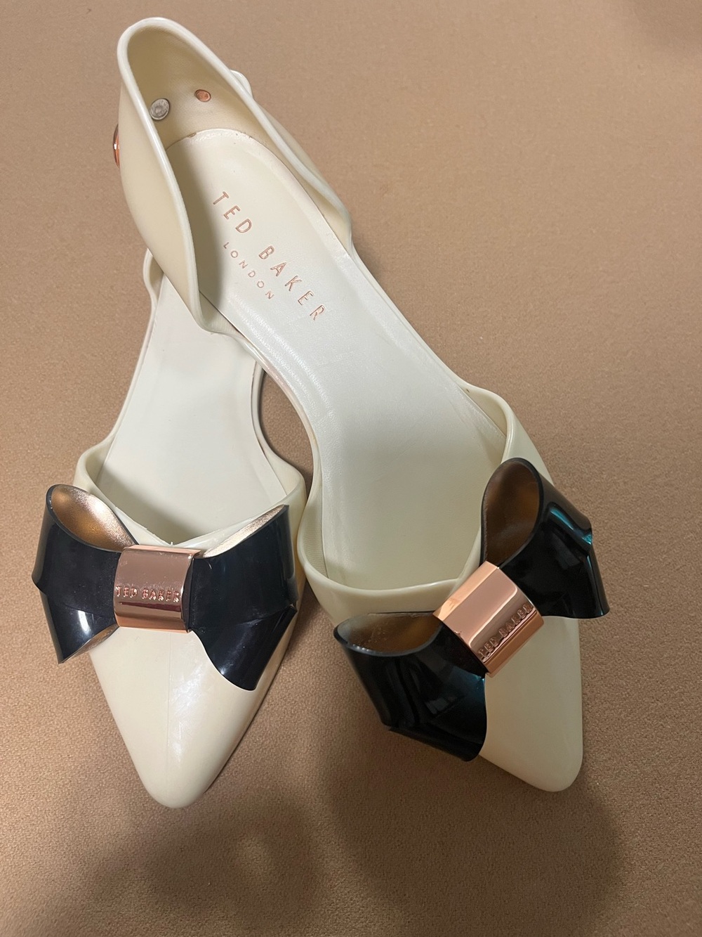 Ted Baker Cream Lela 
Jelly Flats with Black Bow and Rose-Gold Details